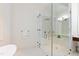 Modern bathroom with a frameless glass shower, elegant fixtures, and white tiled walls at 1820 Oatlands Court Ct, Wake Forest, NC 27587