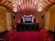 Unique home theater room with red carpet, tented ceiling, hanging lights, and castle-themed decor at 1820 Oatlands Court Ct, Wake Forest, NC 27587