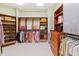 Spacious walk-in closet with custom wood shelving and ample storage space for clothing and accessories at 1820 Oatlands Court Ct, Wake Forest, NC 27587