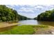 Beautiful water view surrounded by mature trees underneath a partly cloudy sky at 1820 Oatlands Court Ct, Wake Forest, NC 27587