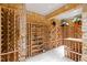 Spacious wine cellar with stone walls, custom racking, and ample storage at 1820 Oatlands Court Ct, Wake Forest, NC 27587