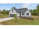 White house with stone accents and a two-car garage at 45 Leisure Ln, Louisburg, NC 27549