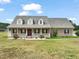 Charming brick home with a large, inviting front porch and well-manicured lawn at 2674 Stanton Hill Rd, Cameron, NC 28326