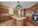 Kitchen features a center island, stainless steel appliances, and warm wood cabinets at 2674 Stanton Hill Rd, Cameron, NC 28326