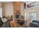 Spacious living room with a grand stone fireplace and views of the dining area at 2674 Stanton Hill Rd, Cameron, NC 28326