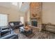 Cozy living room features a stone fireplace, wood floors, and comfortable seating at 2674 Stanton Hill Rd, Cameron, NC 28326