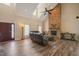 Bright living room featuring a tall stone fireplace, wood floors, and ample natural light at 2674 Stanton Hill Rd, Cameron, NC 28326