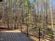 A backyard deck with a view of a beautiful, dense forest beyond at 7621 Falls Creek Ln, Raleigh, NC 27614