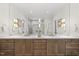 Bathroom featuring double vanity, a large mirror, and modern lighting fixtures creating a bright and functional space at 7621 Falls Creek Ln, Raleigh, NC 27614