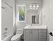 Bathroom with white tiled shower/tub and gray cabinet sink at 7621 Falls Creek Ln, Raleigh, NC 27614
