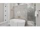 A modern bathroom features a freestanding tub, glass shower, and elegant tile work, creating a spa-like experience at 7621 Falls Creek Ln, Raleigh, NC 27614