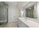 Bathroom featuring tiled flooring, walk-in shower, gray cabinets and quartz counters at 7621 Falls Creek Ln, Raleigh, NC 27614