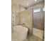Spa-like bathroom featuring a freestanding tub, glass shower, and modern finishes at 7621 Falls Creek Ln, Raleigh, NC 27614