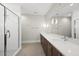 This primary bathroom features a glass shower, double sinks, and ample counter space with modern fixtures at 7621 Falls Creek Ln, Raleigh, NC 27614