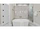 A modern bathroom features a freestanding tub, glass shower, and elegant tile work, creating a spa-like experience at 7621 Falls Creek Ln, Raleigh, NC 27614