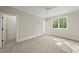 Bright bedroom featuring plush carpeting, a ceiling fan, ensuite bathroom and walk-in closet at 7621 Falls Creek Ln, Raleigh, NC 27614