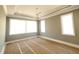 Spacious bedroom with tray ceiling, neutral walls and large windows at 7621 Falls Creek Ln, Raleigh, NC 27614