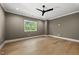 Spacious room with hardwood floors, neutral paint, ceiling fan and great natural light at 7621 Falls Creek Ln, Raleigh, NC 27614