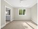 Bright bedroom featuring plush carpeting, a ceiling fan, and an ensuite bathroom at 7621 Falls Creek Ln, Raleigh, NC 27614