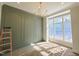 Dining room featuring modern chandelier lighting, arch wall trim, and natural light from large window at 7621 Falls Creek Ln, Raleigh, NC 27614