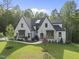 Beautiful two-story home with professionally landscaped yard, colorful flowerbeds, and mature trees at 7621 Falls Creek Ln, Raleigh, NC 27614