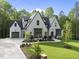 Stunning traditional two-story home with a well-manicured lawn and elegant landscaping at 7621 Falls Creek Ln, Raleigh, NC 27614