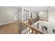 Spacious foyer with hardwood floors, custom built-in shelving, and iron stair railing, offering a stylish entrance at 7621 Falls Creek Ln, Raleigh, NC 27614