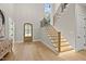 Welcoming foyer boasting hardwood floors, a stylish staircase, and a charming front door at 7621 Falls Creek Ln, Raleigh, NC 27614