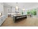 Well-lit kitchen with an island, bar seating, and views into other parts of the home at 7621 Falls Creek Ln, Raleigh, NC 27614