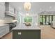 Open kitchen with a large island, state-of-the-art appliances, and a view into the living room at 7621 Falls Creek Ln, Raleigh, NC 27614