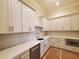 Modern kitchen features white cabinets, stainless steel appliances, quartz countertops, and gold hardware at 7621 Falls Creek Ln, Raleigh, NC 27614