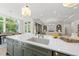 Kitchen island with sink, bar seating, and open views into the living room and dining area at 7621 Falls Creek Ln, Raleigh, NC 27614