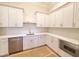 Modern kitchen features white cabinets, stainless steel appliances, quartz countertops, and gold hardware at 7621 Falls Creek Ln, Raleigh, NC 27614