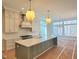 New kitchen features stainless steel appliances, large island with seating, and modern pendant lighting at 7621 Falls Creek Ln, Raleigh, NC 27614