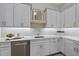 Bright kitchenette featuring white countertops, shaker cabinets, stylish backsplash, and gold hardware at 7621 Falls Creek Ln, Raleigh, NC 27614