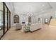 Open-concept living room with a fireplace, built-in shelving, and access to other parts of the home at 7621 Falls Creek Ln, Raleigh, NC 27614