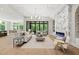 Elegant living room featuring a marble fireplace, recessed lighting, and large windows offering outdoor views at 7621 Falls Creek Ln, Raleigh, NC 27614