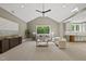 Bright living room with a vaulted ceiling, hardwood floors, and a connecting kitchen at 7621 Falls Creek Ln, Raleigh, NC 27614