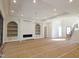 Spacious living room featuring a decorative ceiling, modern chandelier, fireplace, and built-in shelving at 7621 Falls Creek Ln, Raleigh, NC 27614