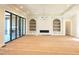 Bright living room with a fireplace, built-in shelving, decorative ceiling, and large sliding glass doors to a deck at 7621 Falls Creek Ln, Raleigh, NC 27614
