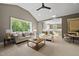 Bright living room with hardwood floors and a view of a connected kitchen at 7621 Falls Creek Ln, Raleigh, NC 27614