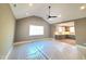 Bright living room featuring a vaulted ceiling and view to the kitchen offering modern design and comfort at 7621 Falls Creek Ln, Raleigh, NC 27614