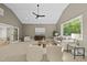 Bright living room with a vaulted ceiling, neutral walls, modern furnishings, and hardwood floors at 7621 Falls Creek Ln, Raleigh, NC 27614
