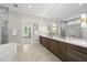 Spa-like main bathroom with a double vanity, soaking tub, and a glass-enclosed shower at 7621 Falls Creek Ln, Raleigh, NC 27614