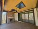 Covered patio features skylights, a ceiling fan, and a cozy brick fireplace at 7621 Falls Creek Ln, Raleigh, NC 27614