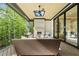 Spacious covered porch with cozy seating and a fireplace, perfect for outdoor enjoyment at 7621 Falls Creek Ln, Raleigh, NC 27614