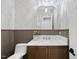 Elegant powder room featuring designer wallpaper, a marble countertop, and stylish fixtures for a luxurious feel at 7621 Falls Creek Ln, Raleigh, NC 27614