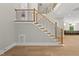 Elegant staircase featuring wood treads, black metal railings, and ambient lighting at 7621 Falls Creek Ln, Raleigh, NC 27614