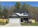 Charming two-story home with a gray-and-white color scheme, a two-car garage, and a well-manicured lawn at 85 Shenandoah Ct, Clayton, NC 27520