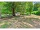 Large, level lot surrounded by mature trees and outbuildings at 1844 Brier Ln, Graham, NC 27253